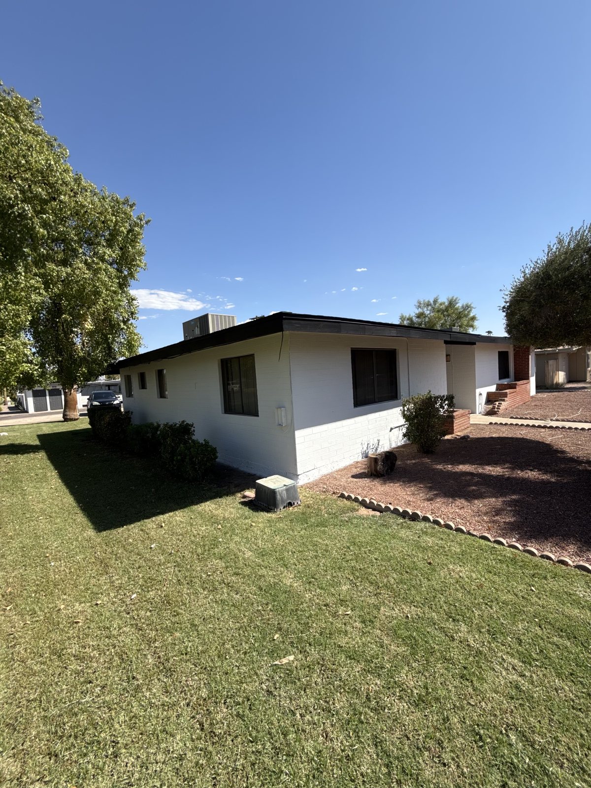 Side elevation of the same home, showing the dark trim line carried the full length of the eaves
