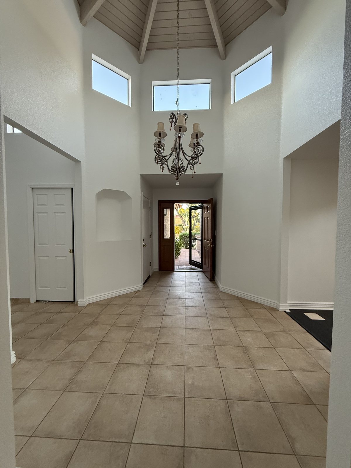 Two-story entry with chandelier and clerestory windows after a whole-interior repaint by Happy Brush Painters